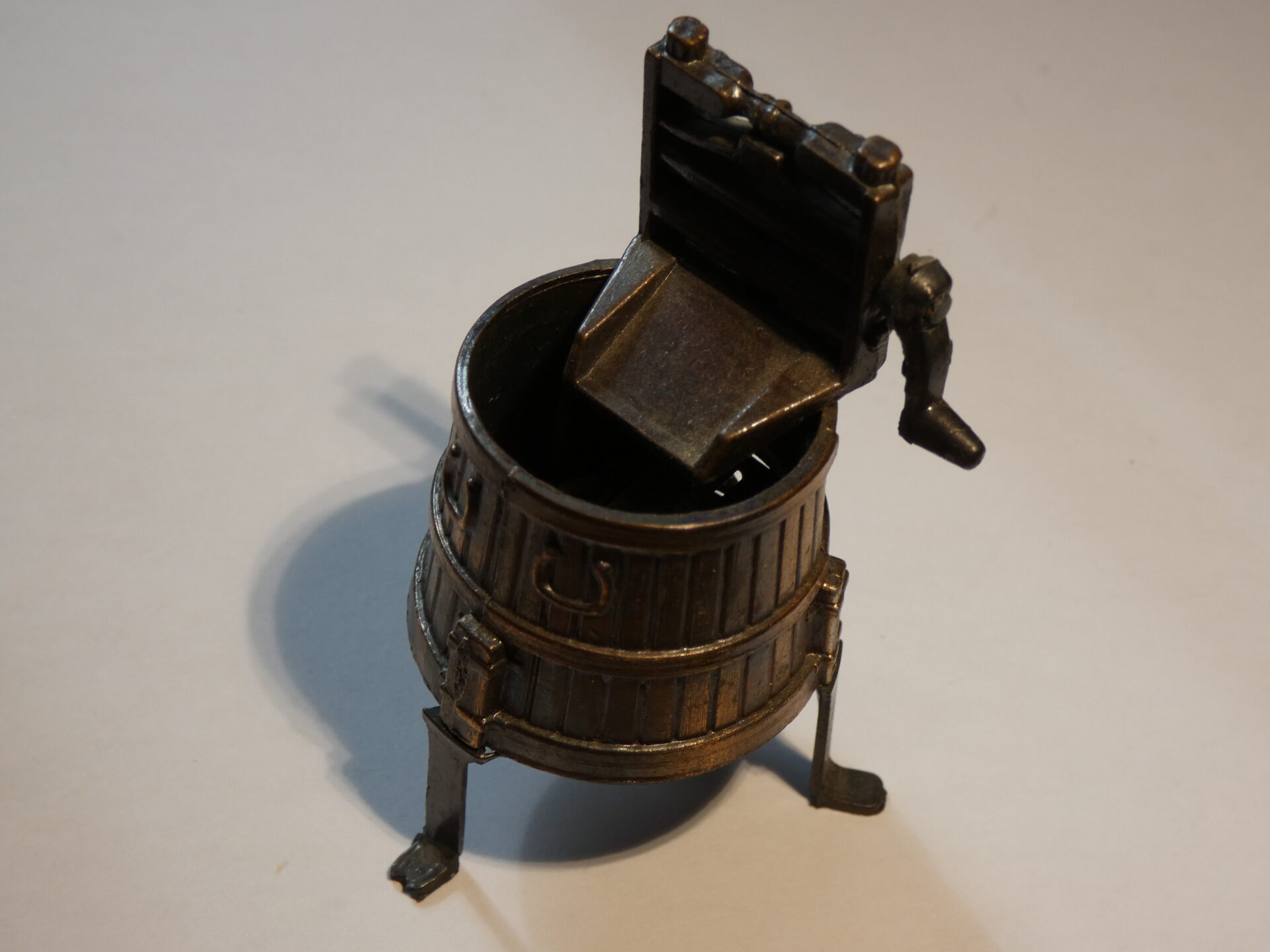 Vintage metal pencil sharpener in bucket shape.