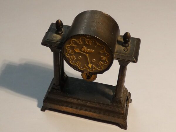 Antique metal clock pencil sharpener.