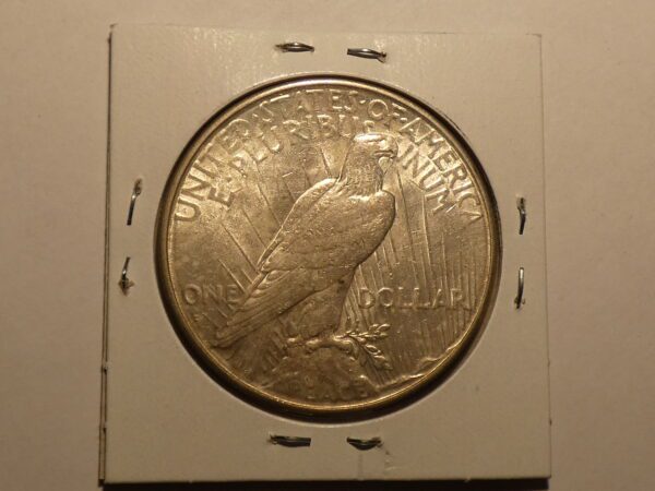 Silver dollar coin with bald eagle.