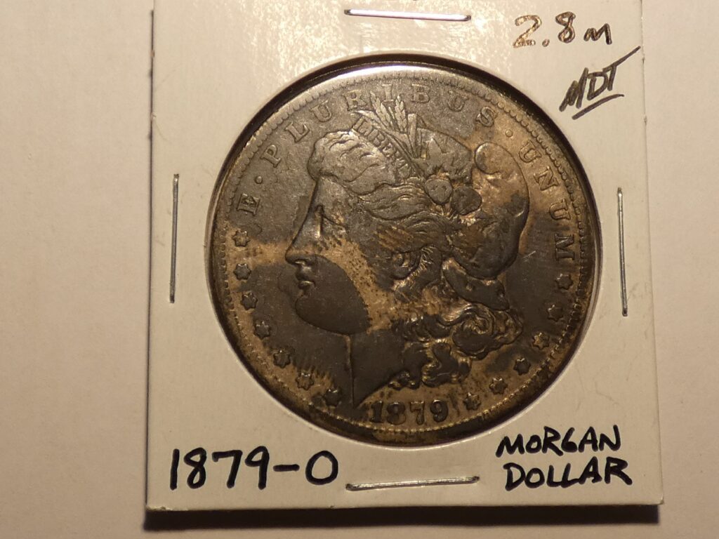 1879 Morgan silver dollar coin.