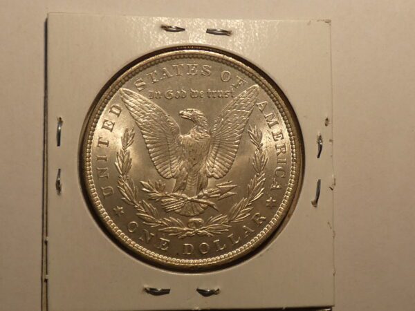 Silver dollar coin with eagle and wreath.