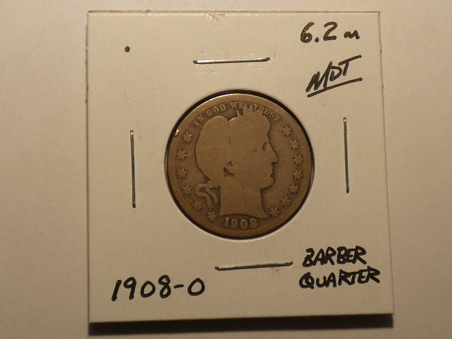 1908 Barber quarter coin in holder.