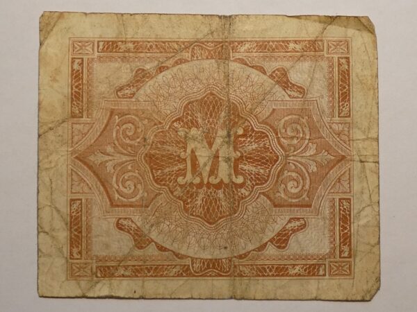 Vintage paper with ornate design and letter M.