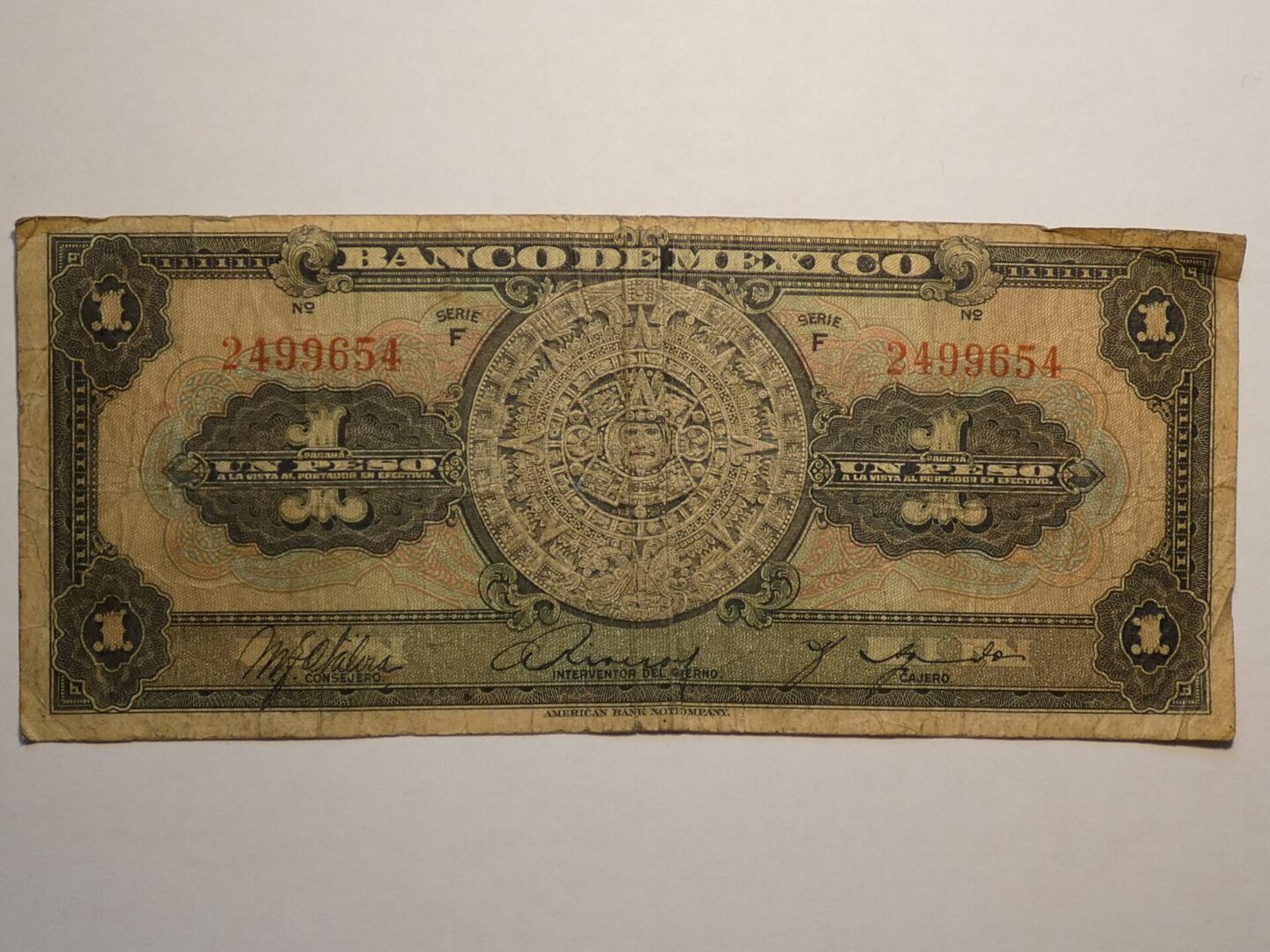 Mexican one peso banknote with Aztec calendar.