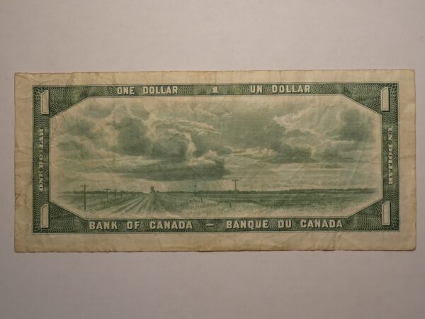 Canadian one dollar bill with cloudy sky.