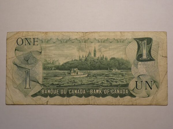 Canadian one dollar bill with Parliament Hill.