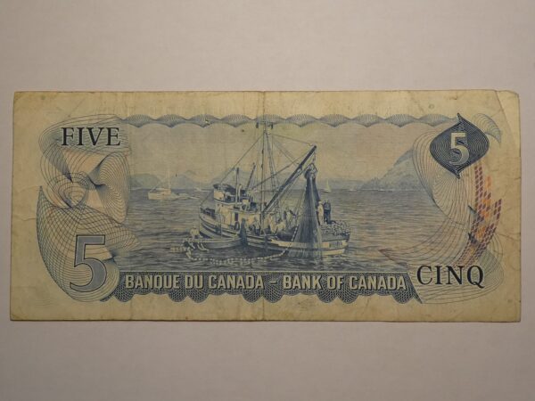 Canadian five dollar bill with a fishing boat.