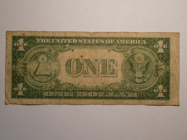 One US dollar bill with wear and tear.