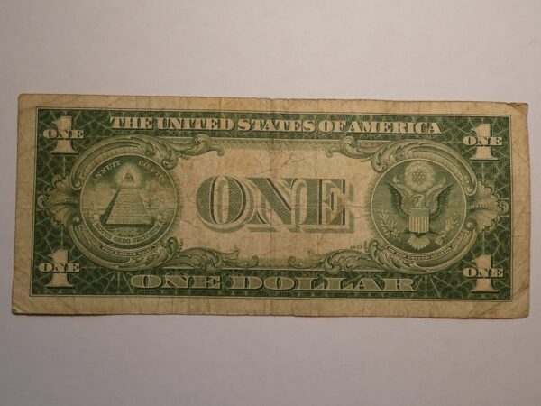 One US dollar bill with worn edges.