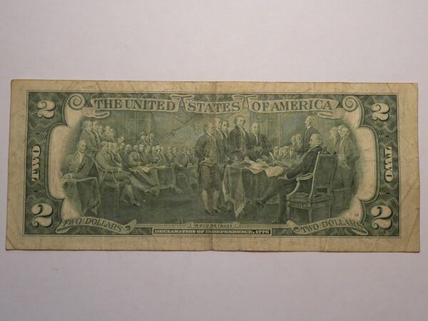 Two dollar bill with signing of Declaration of Independence.