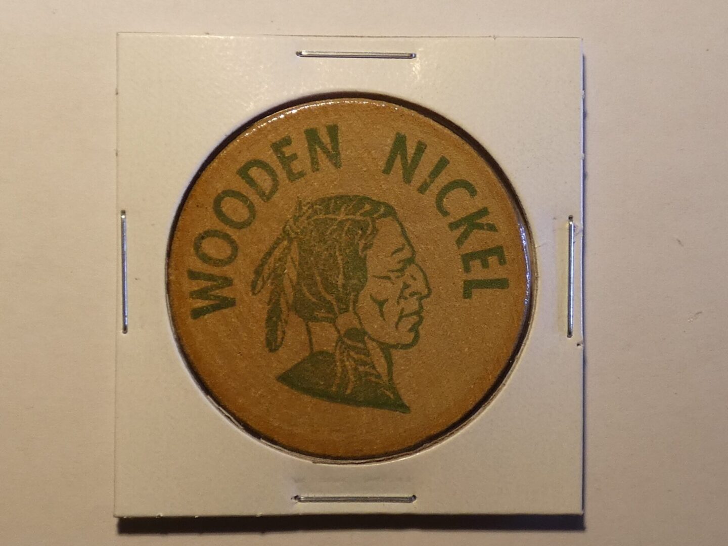 Wooden Nickel token with Native American profile.