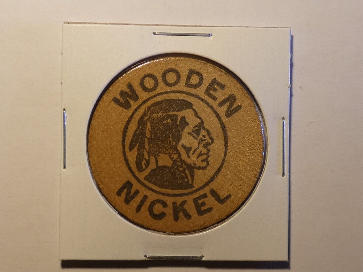 Wooden nickel with Native American profile.