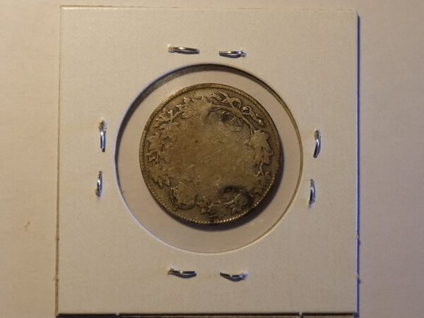 Silver coin with floral design.