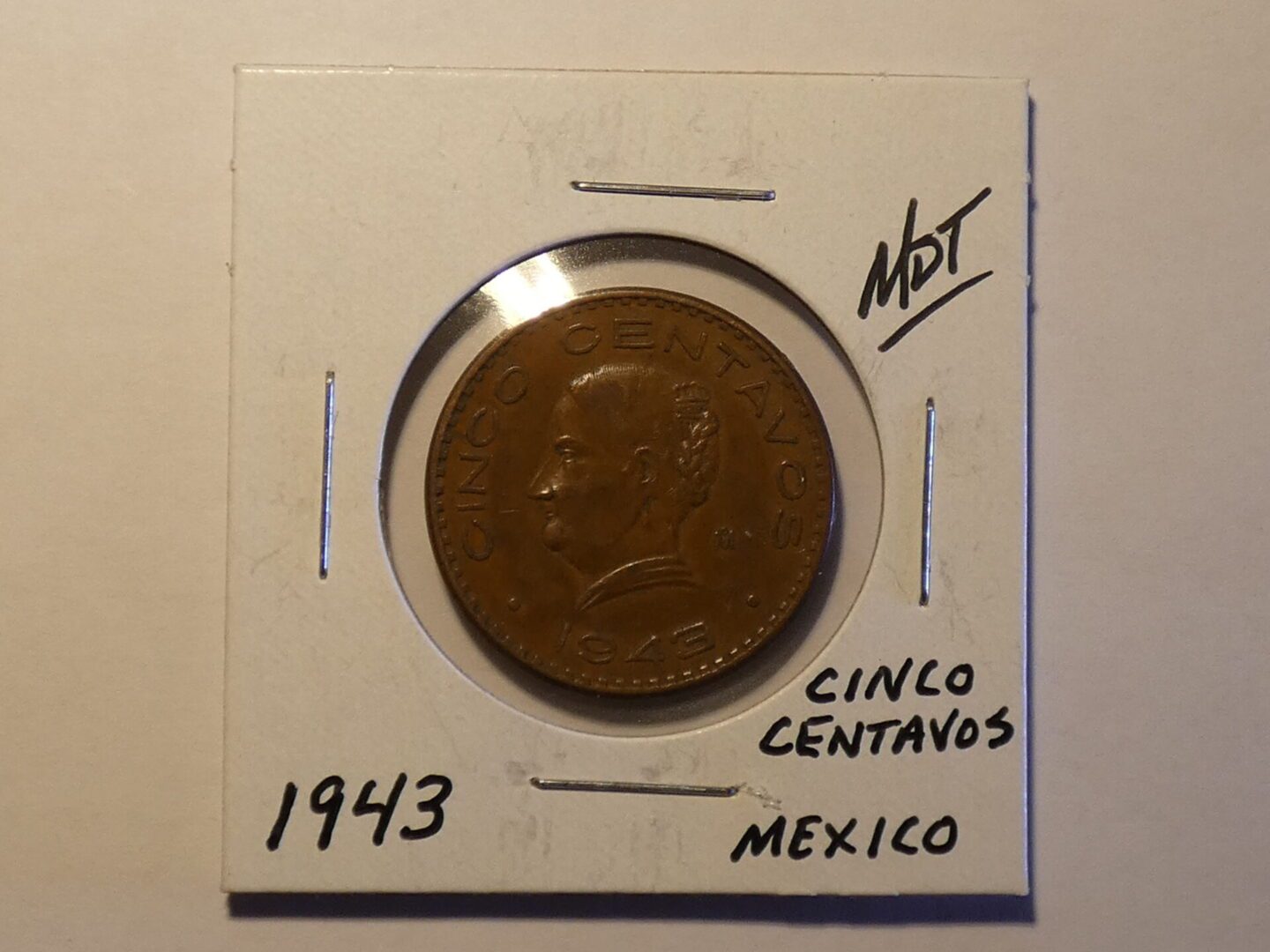 1943 Mexican five centavo coin.