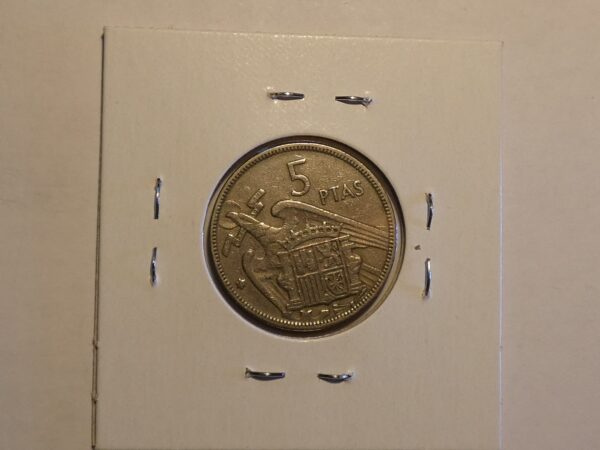 Spanish 5 Ptas coin with eagle design.