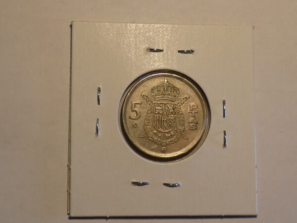 Spanish 5 pesetas coin with coat of arms.