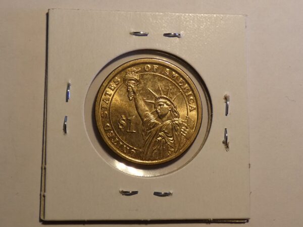 Gold one dollar coin with Statue of Liberty.