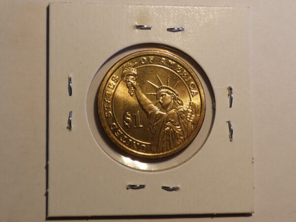 One dollar gold coin with Statue of Liberty.