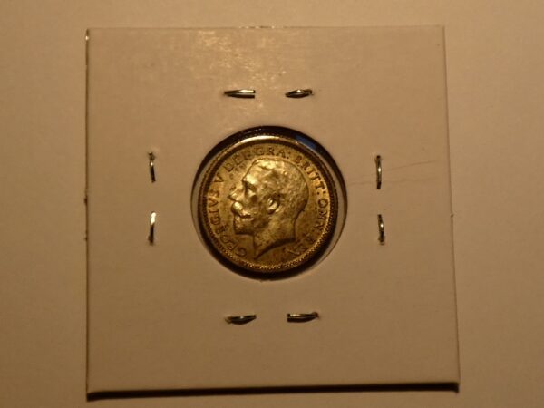 Gold coin with King George V portrait.