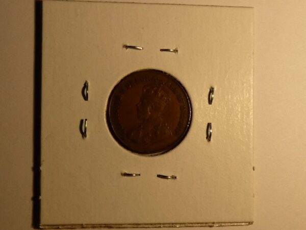 Copper coin in a white holder.