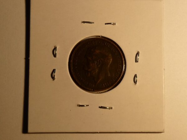 A copper coin with a man's profile.